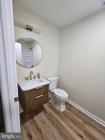 a bathroom with a sink toilet and mirror