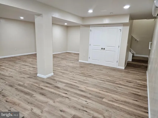 an empty room with wooden floor and white doors