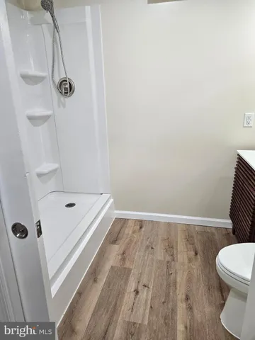 a bathroom with a granite countertop bathtub and toilet