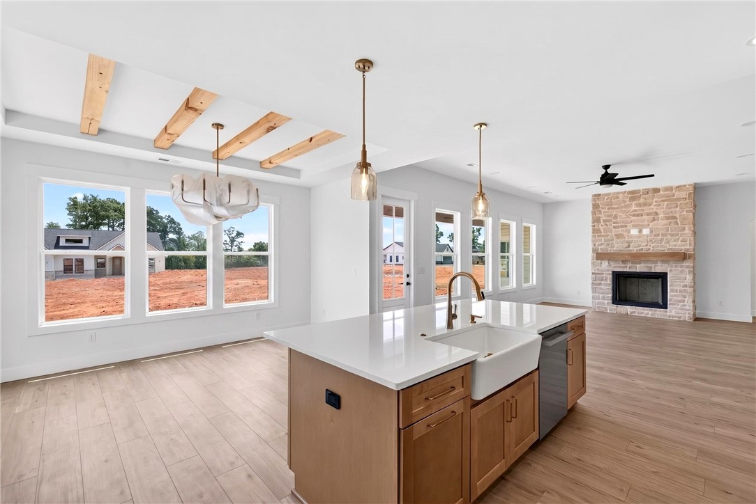 424 Blume Road Anderson, SC 29625 - Photo 10 of 30 An inviting open-concept area boasts a spacious kitchen island and a stone-faced fireplace.