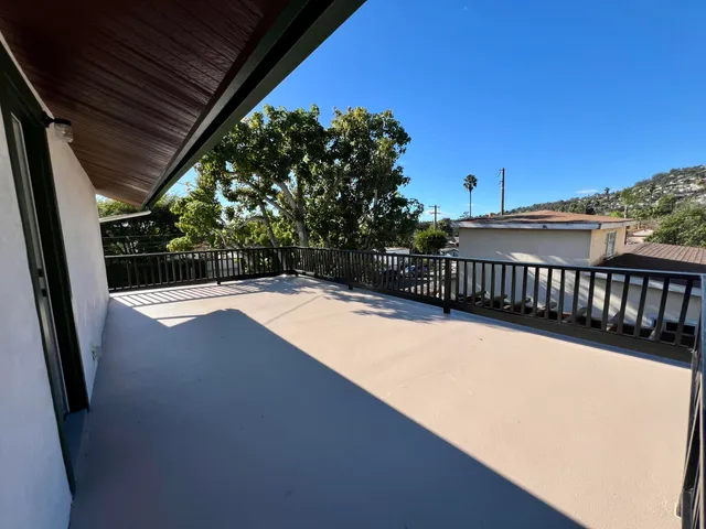 a view of balcony with wooden floor