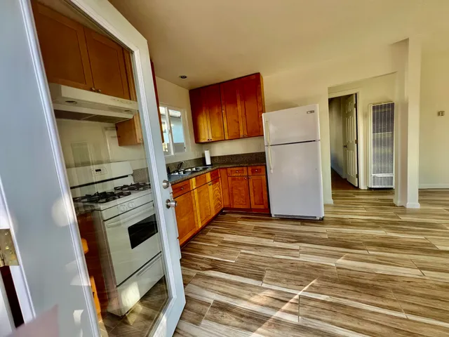 a kitchen with a stove a refrigerator and cabinets