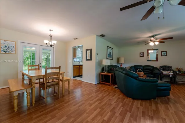 a living room with furniture and a dining table