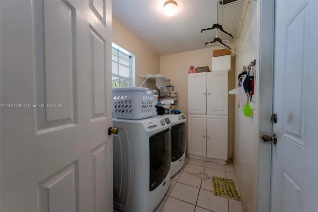 a utility room with closet dryer and washer