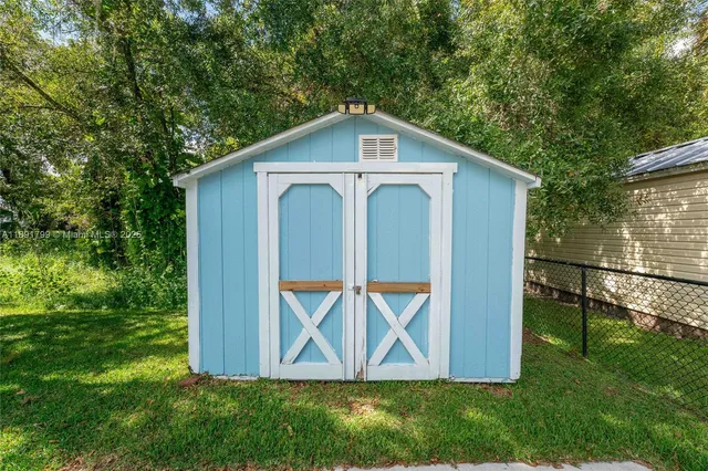 a view of backyard with a barn and a cactus plant