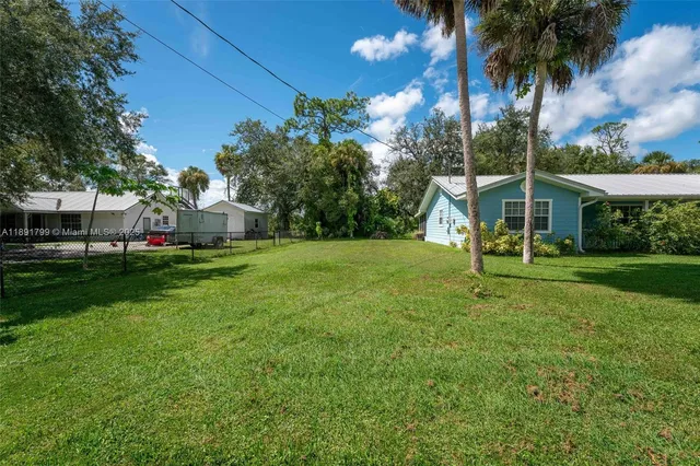 a view of a house with a backyard