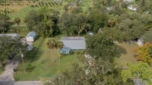 an aerial view of a house with a yard