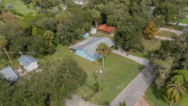 an aerial view of a house with outdoor space and street view