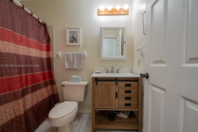 a bathroom with a toilet sink and shower