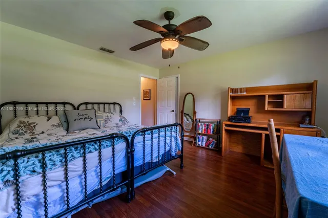 a bedroom with furniture and a wooden floor