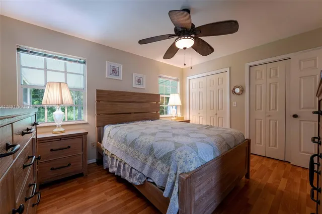 a bedroom with a bed chandelier and a window