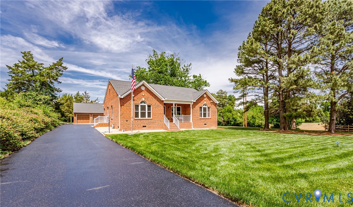 2018 Valentine Road Henrico, VA 23228 - Photo 4 of 65 a front view of a house with a yard and garage