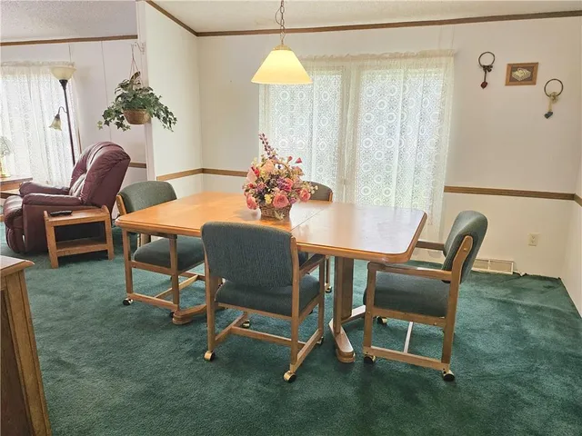 a dining room with furniture potted plants and a table
