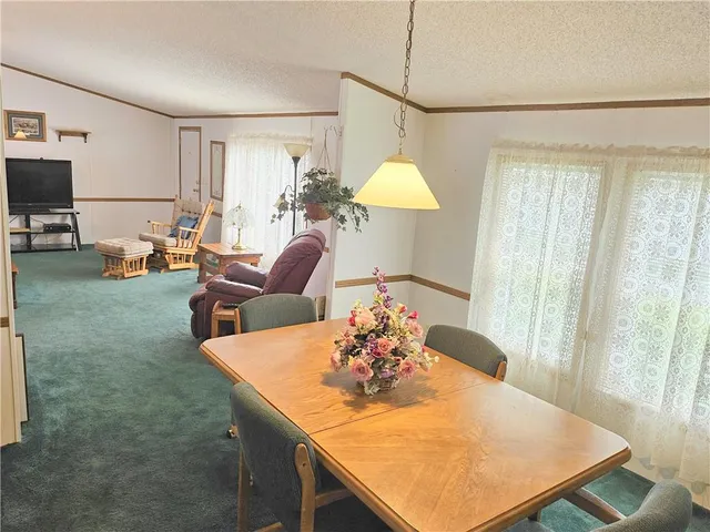 a view of a dining room with furniture and a chandelier