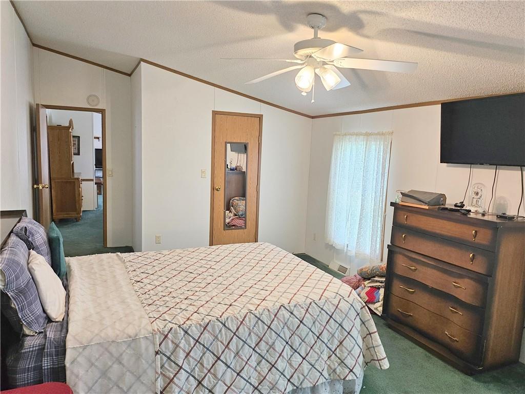 723 Joy Lane Butler, PA 16001 - Photo 22 of 41 a bedroom with a bed and a chandelier