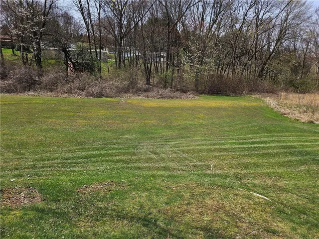 a view of outdoor space with trees all around