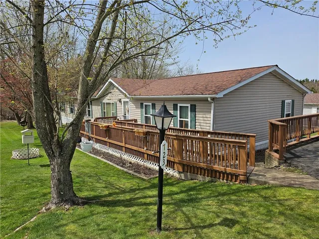 a front view of a house with a yard table and chairs