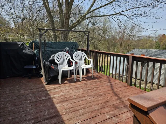 a view of roof deck with wooden floor and seating space