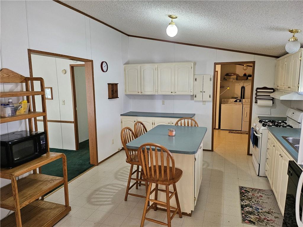 723 Joy Lane Butler, PA 16001 - Photo 7 of 41 a kitchen with stainless steel appliances granite countertop a refrigerator and a stove top oven with wooden floor