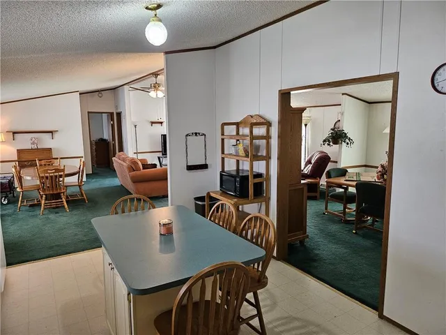 a view of a dining room with furniture and a livingroom