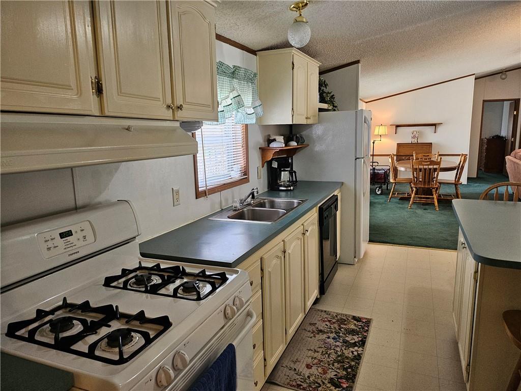 723 Joy Lane Butler, PA 16001 - Photo 9 of 41 a kitchen with a stove a sink and a refrigerator