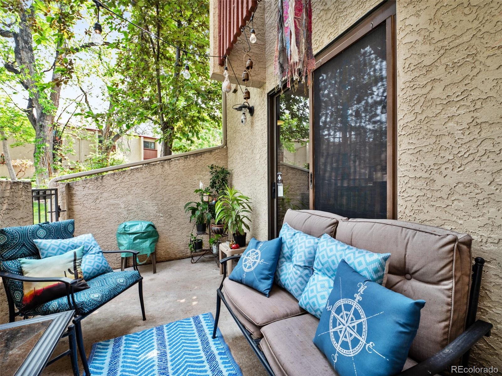 a view of a patio with couches and a potted plant