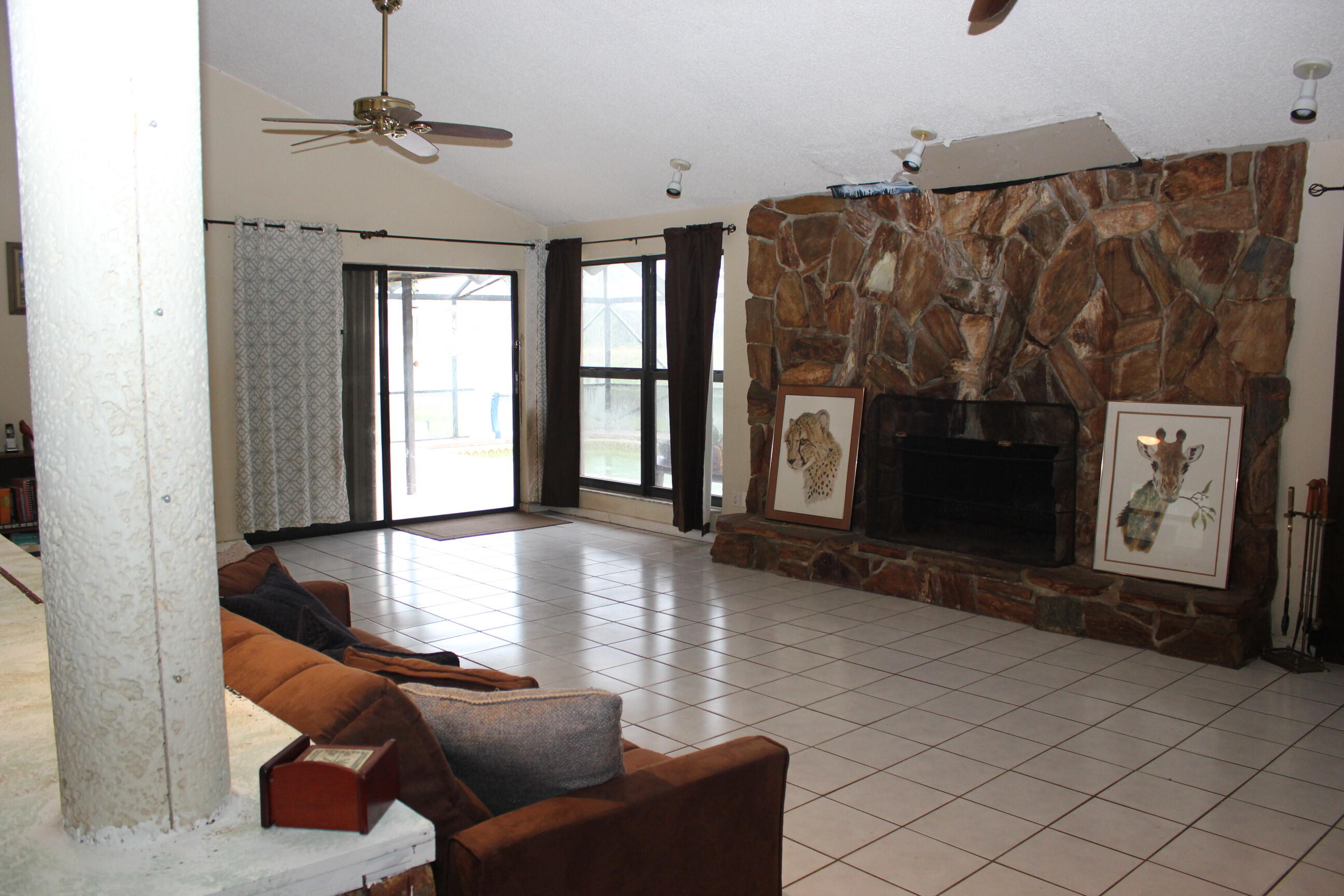 4981 Serafica Drive Lake Worth, FL 33461 - Photo 14 of 44 a living room with furniture and a fireplace