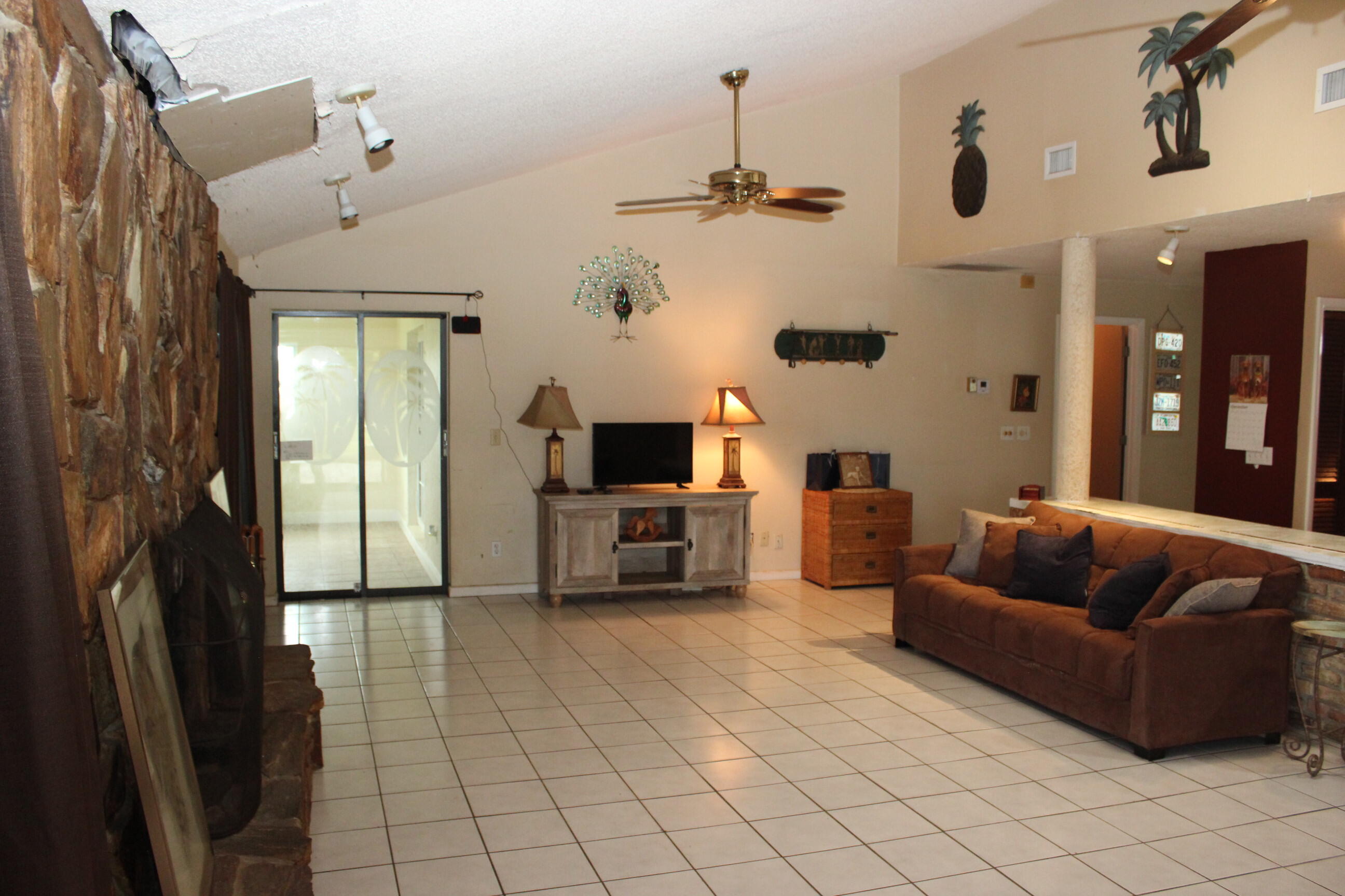 4981 Serafica Drive Lake Worth, FL 33461 - Photo 15 of 44 a living room with furniture and a flat screen tv