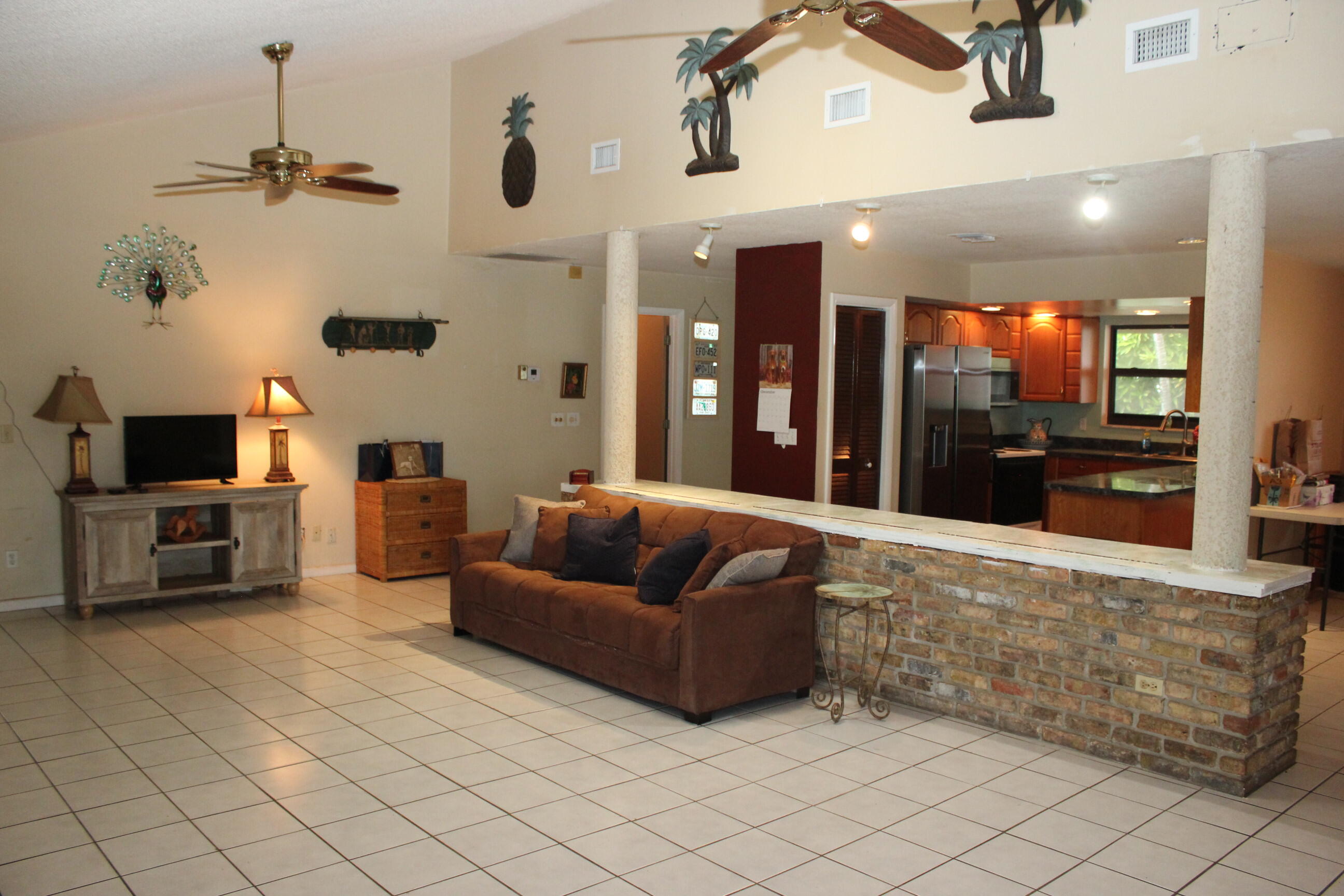 4981 Serafica Drive Lake Worth, FL 33461 - Photo 16 of 44 a living room with furniture and a flat screen tv