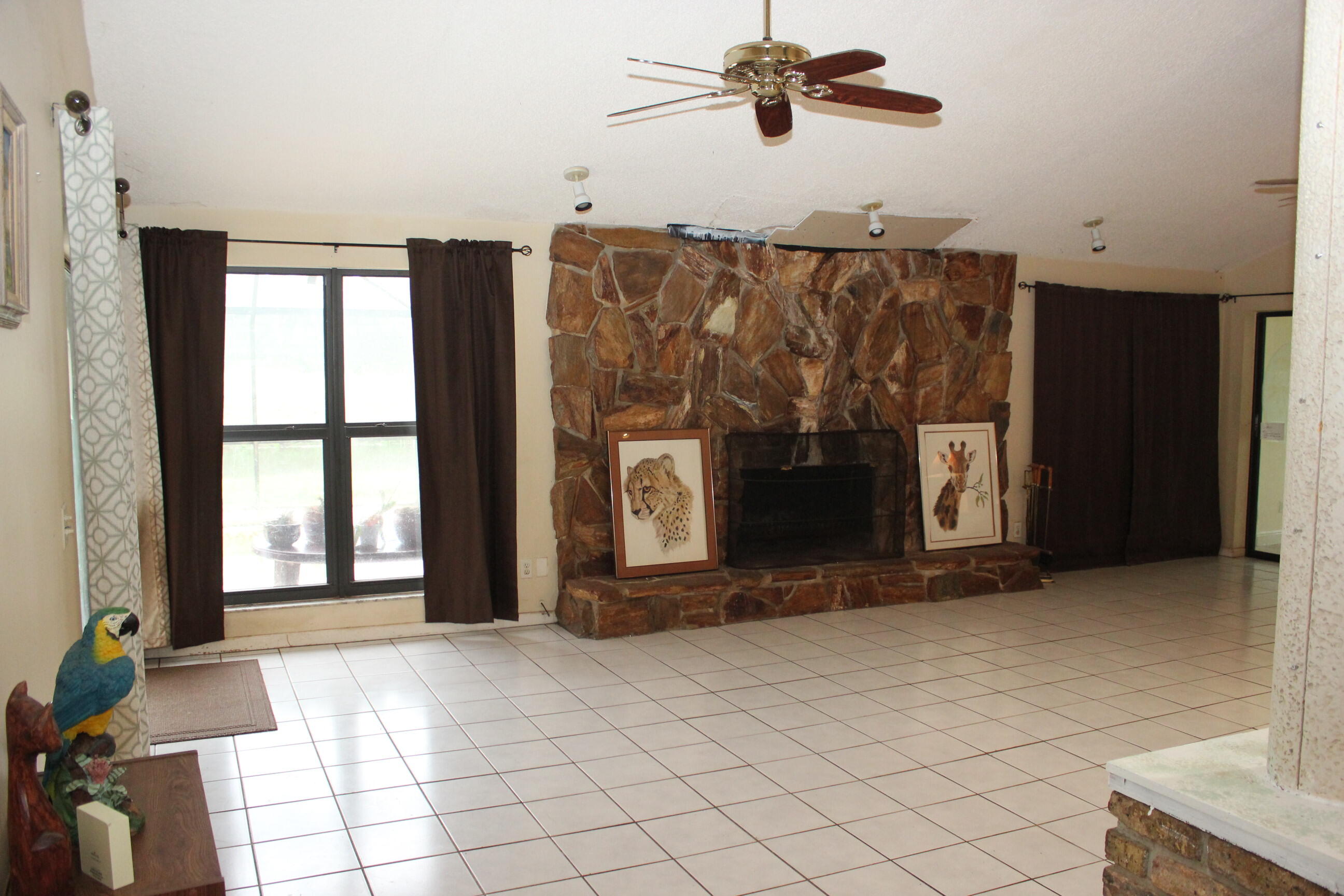 4981 Serafica Drive Lake Worth, FL 33461 - Photo 18 of 44 a view of a livingroom with a fireplace and window