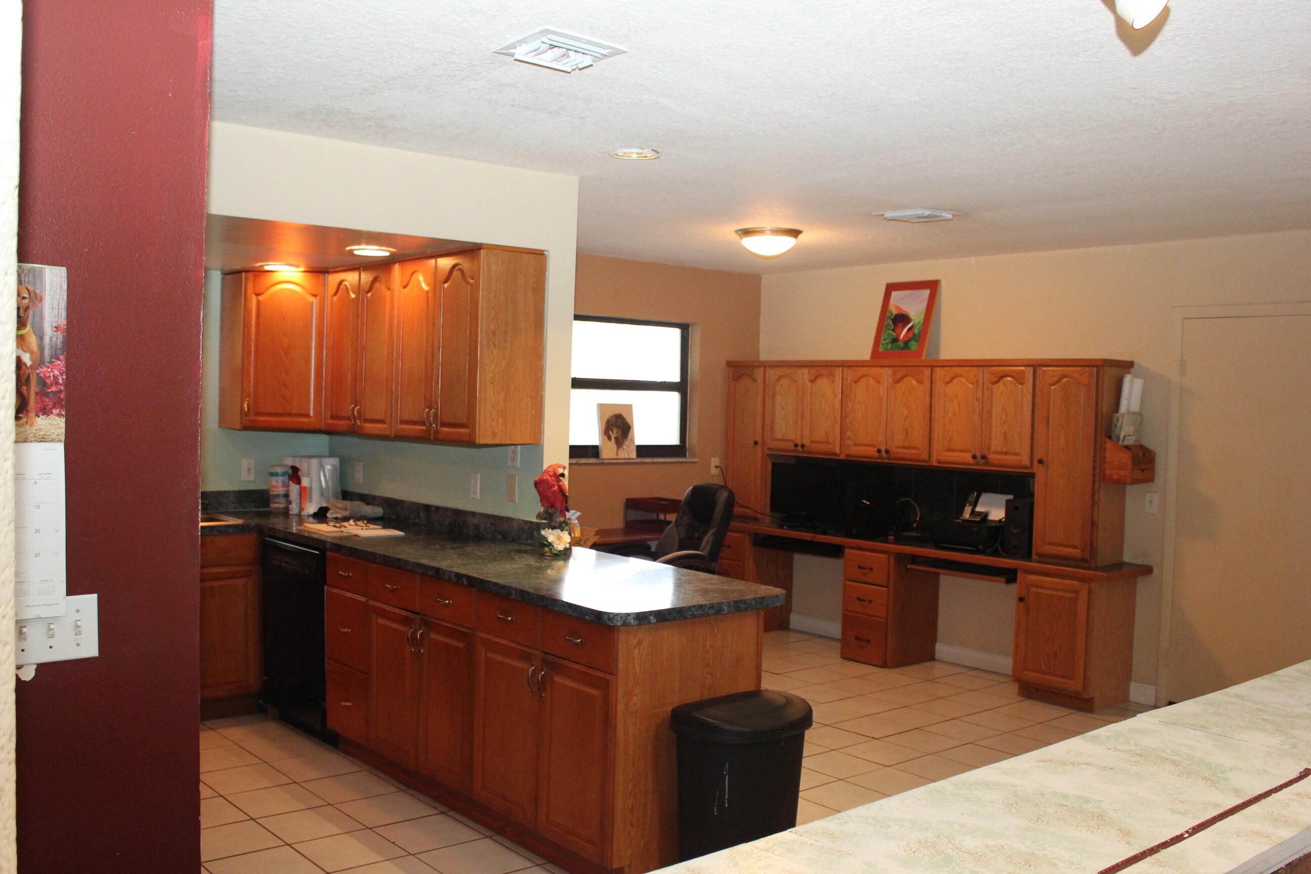 4981 Serafica Drive Lake Worth, FL 33461 - Photo 22 of 44 a kitchen with granite countertop a sink and a stove top oven
