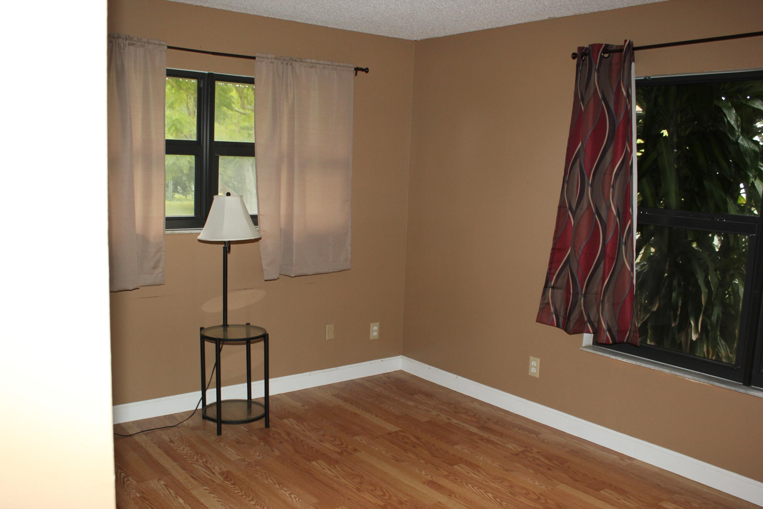 4981 Serafica Drive Lake Worth, FL 33461 - Photo 27 of 44 a view of a room with wooden floor and a carpet