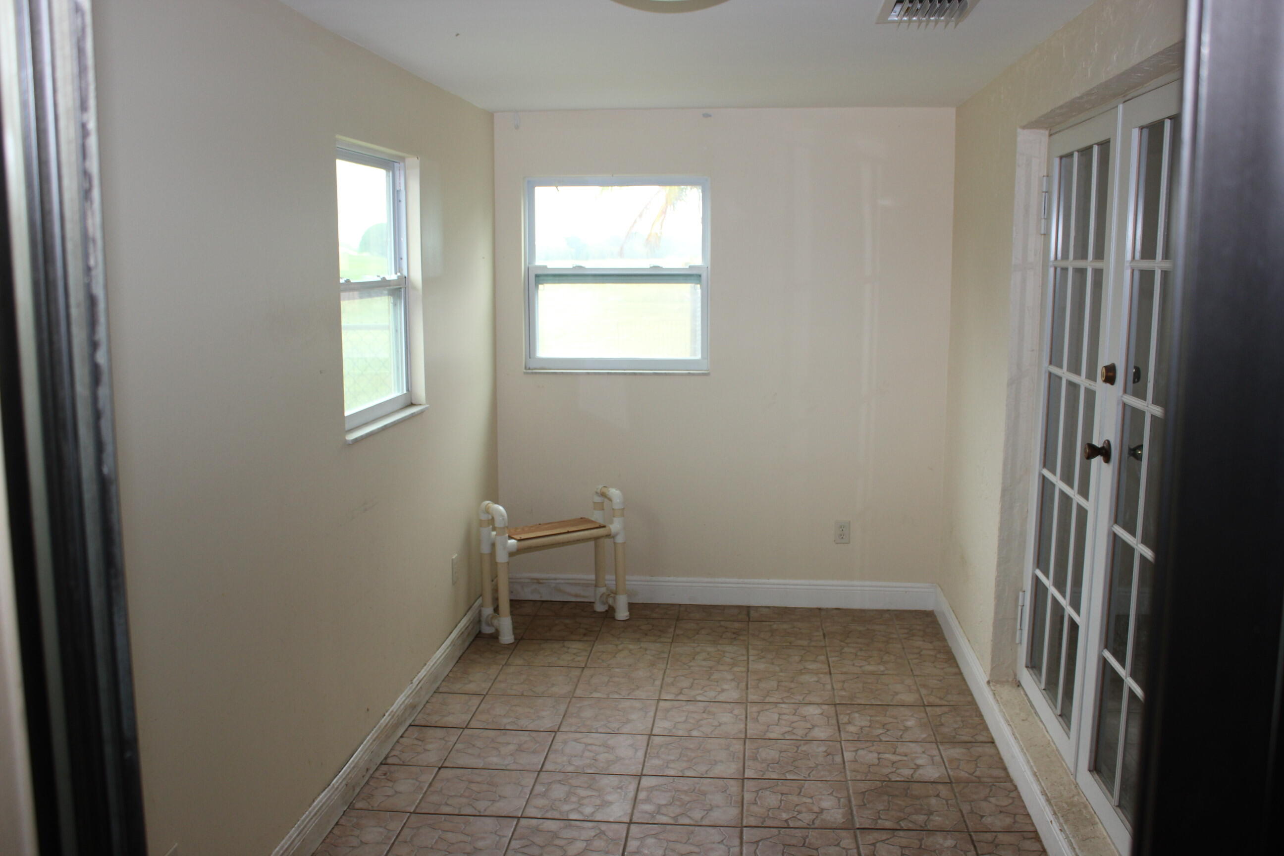 4981 Serafica Drive Lake Worth, FL 33461 - Photo 28 of 44 an empty room with windows