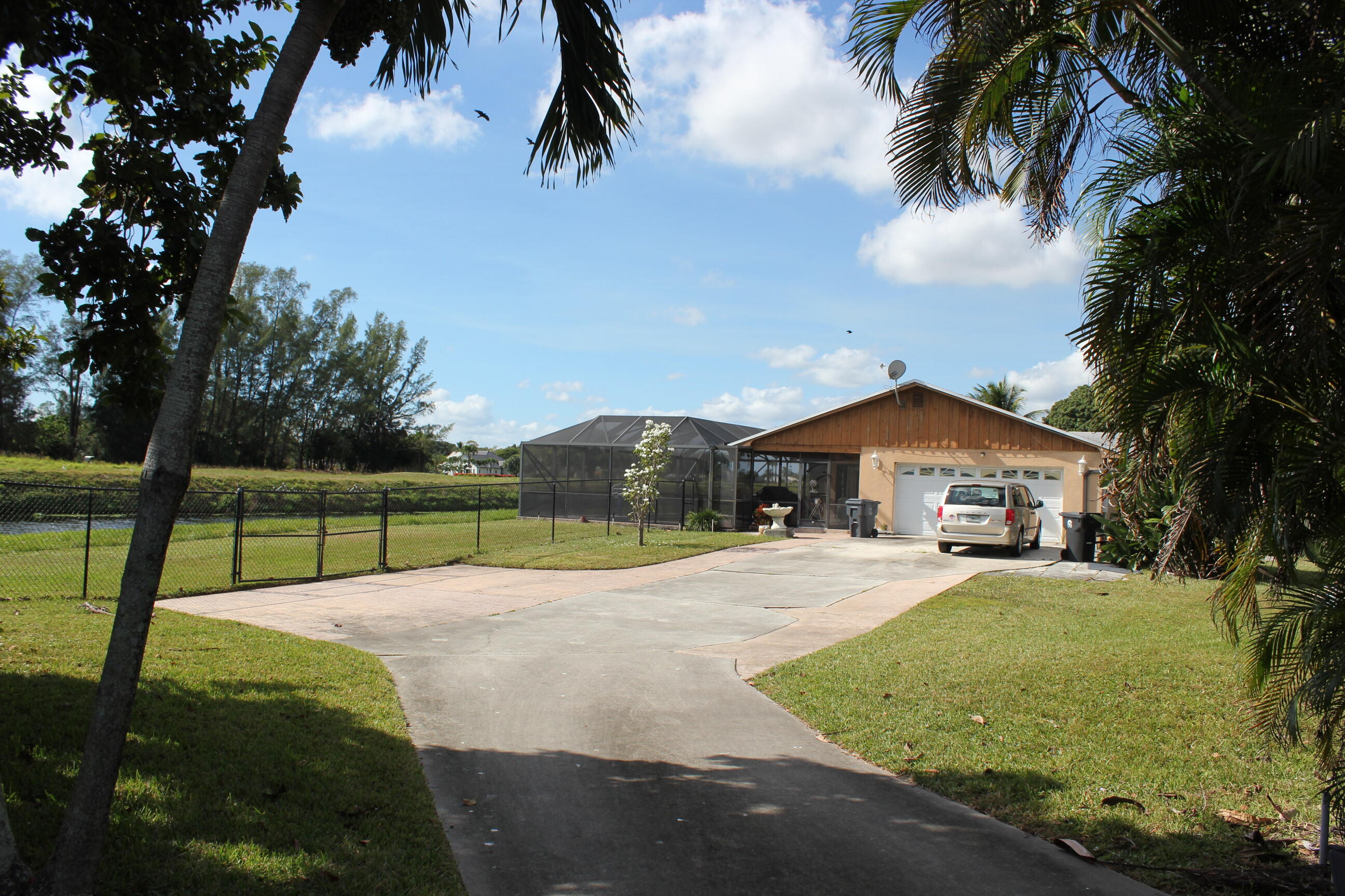 4981 Serafica Drive Lake Worth, FL 33461 - Photo 3 of 44 a view of a backyard with a garden and entertaining space