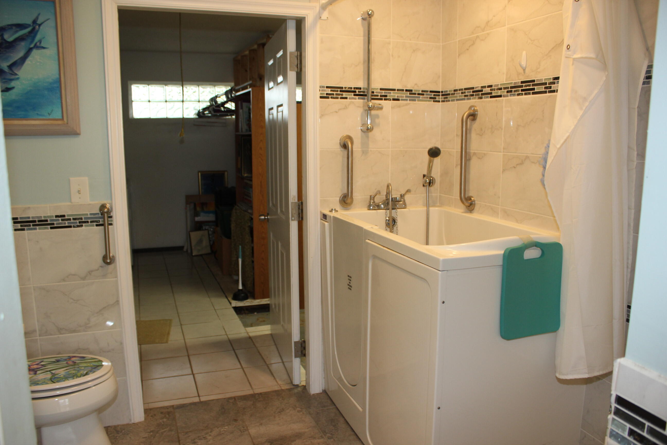 4981 Serafica Drive Lake Worth, FL 33461 - Photo 34 of 44 a bathroom with a sink a toilet and shower