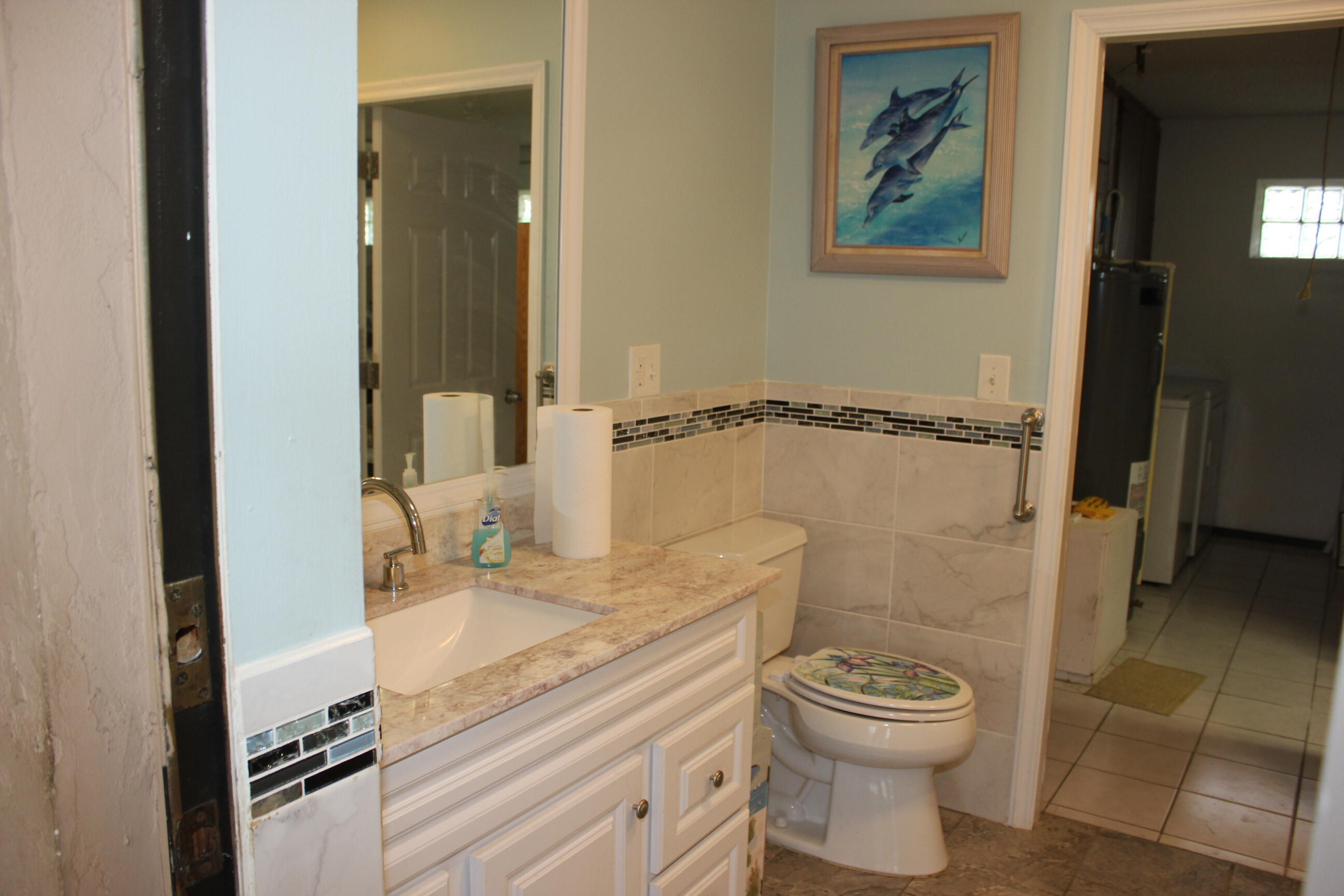 4981 Serafica Drive Lake Worth, FL 33461 - Photo 35 of 44 a bathroom with a granite countertop toilet sink and mirror