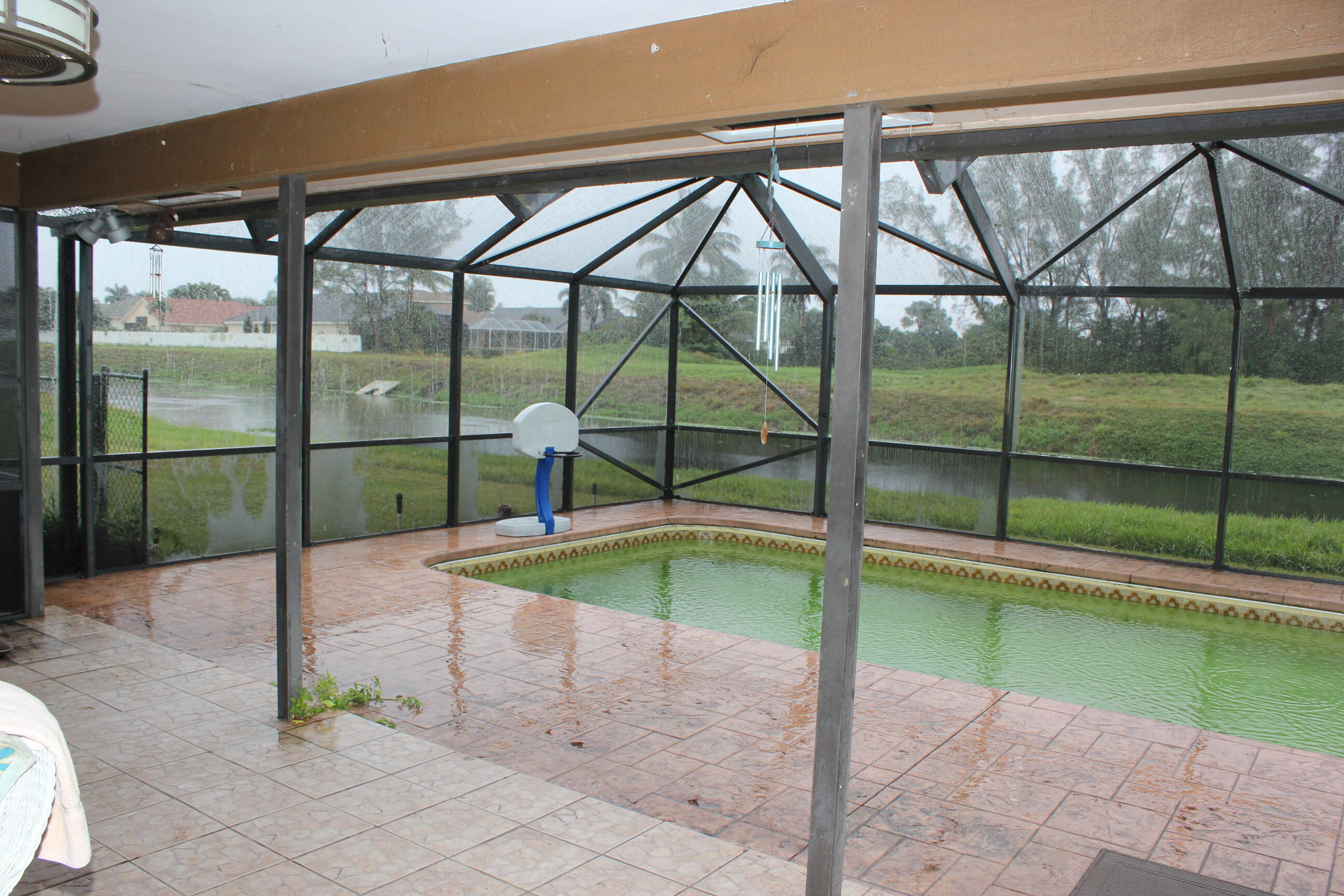 4981 Serafica Drive Lake Worth, FL 33461 - Photo 37 of 44 a swimming pool with an outdoor seating yard and roof