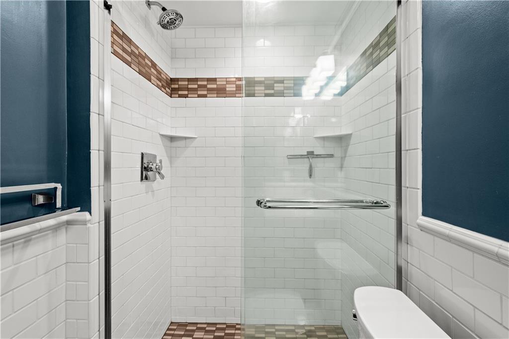 5922 Howe Street, Unit 204 Pittsburgh, PA 15232 - Photo 24 of 42 Glass-enclosed shower and attractive tilework create a polished, updated feel.