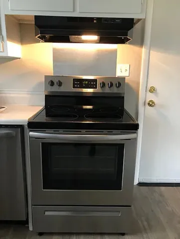 a stove top oven sitting inside of a kitchen