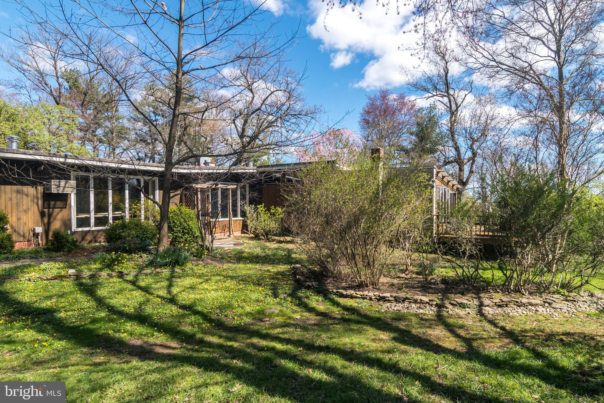 4453 Province Line Road Princeton, NJ 08540 - Photo 2 of 22 a view of house with backyard and sitting area