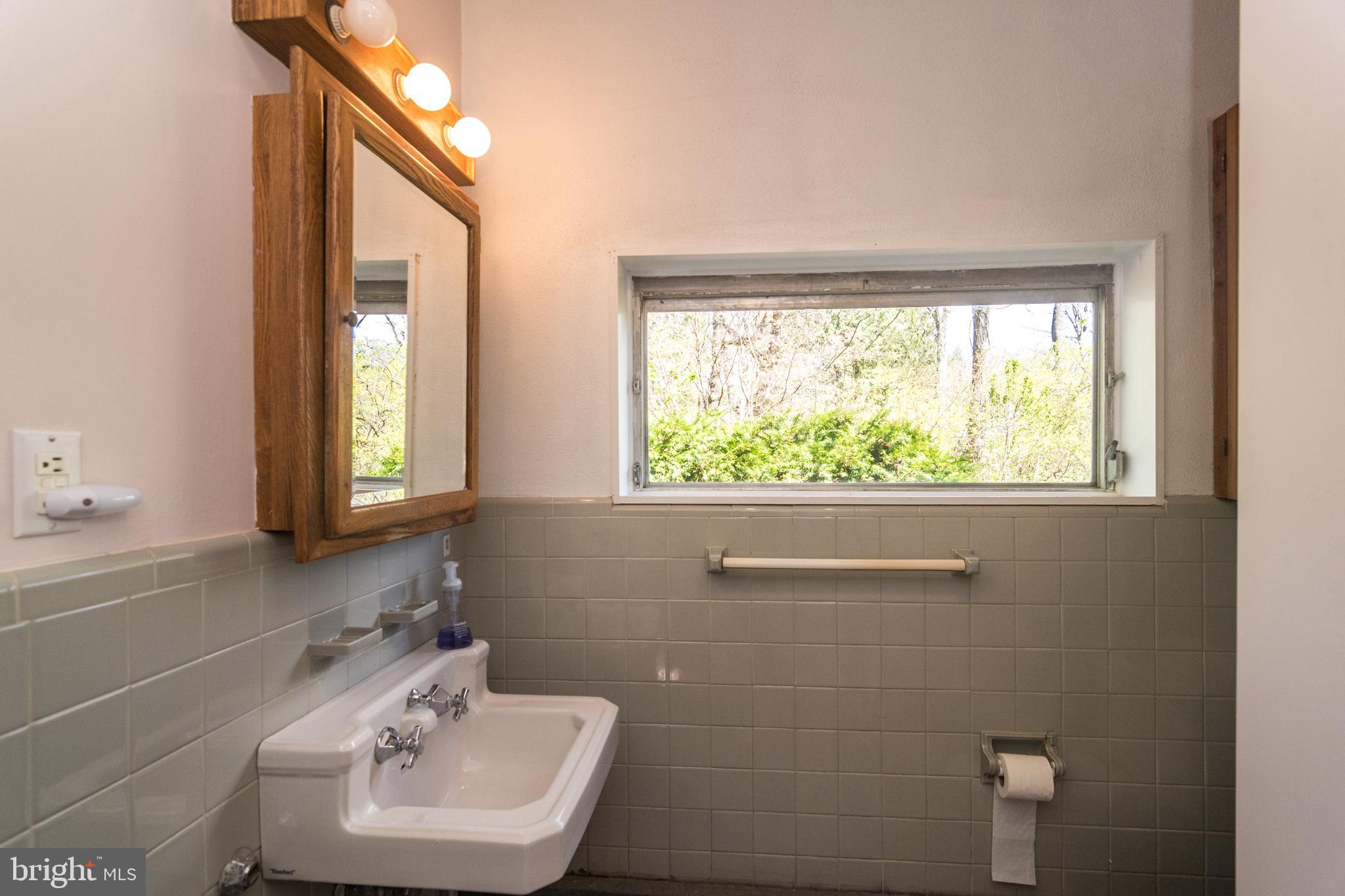 4453 Province Line Road Princeton, NJ 08540 - Photo 22 of 22 a bathroom with a sink a window and a mirror