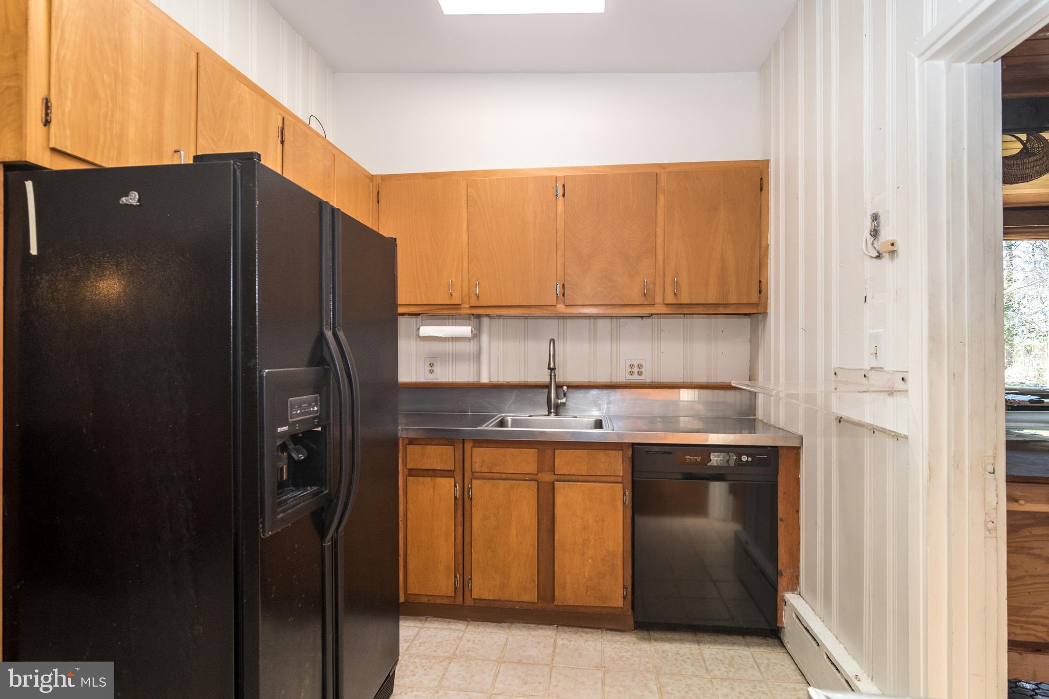 4453 Province Line Road Princeton, NJ 08540 - Photo 8 of 22 a kitchen with a sink a refrigerator and cabinets