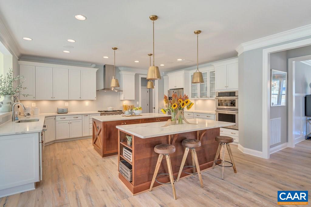 2134 Ridgetop Drive Charlottesville, VA 22903 - Photo 13 of 49 a kitchen with stainless steel appliances granite countertop a stove refrigerator and white cabinets with wooden floor