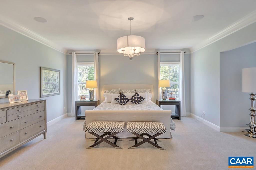 2134 Ridgetop Drive Charlottesville, VA 22903 - Photo 26 of 49 a bedroom with a bed and a chandelier