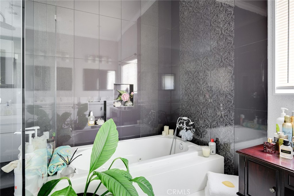 10461 Hillhaven Avenue Tujunga, CA 91042 - Photo 14 of 31 a bathroom with a sink mirror and tub