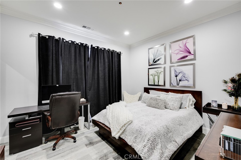 10461 Hillhaven Avenue Tujunga, CA 91042 - Photo 16 of 31 a bedroom with a bed and furniture