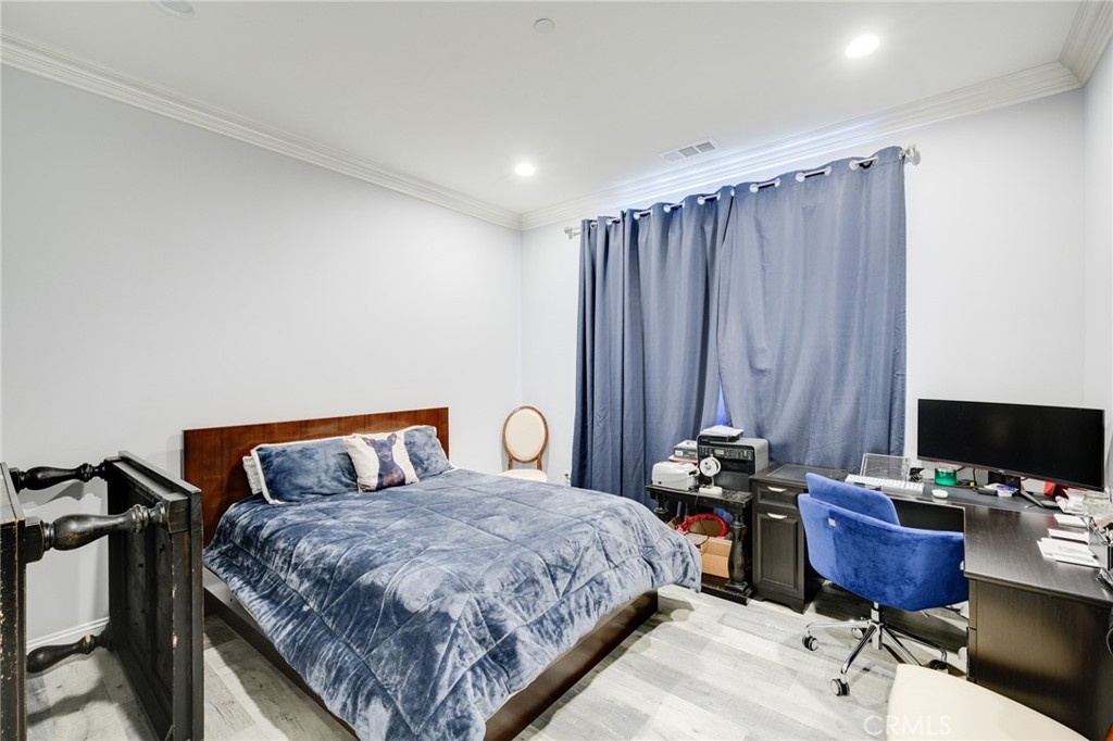 10461 Hillhaven Avenue Tujunga, CA 91042 - Photo 19 of 31 a bedroom with a bed and a desk