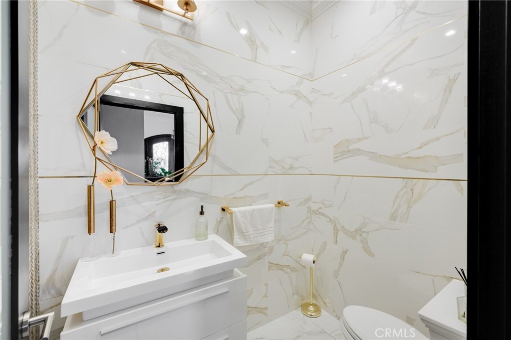10461 Hillhaven Avenue Tujunga, CA 91042 - Photo 21 of 31 a bathroom with a sink and mirror with toilet