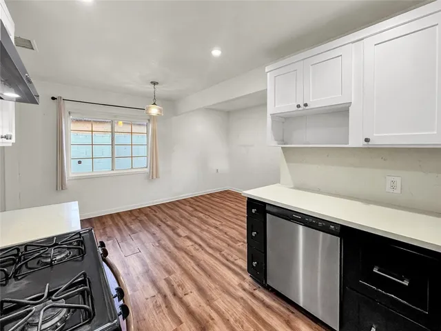 a kitchen with a stove and a window