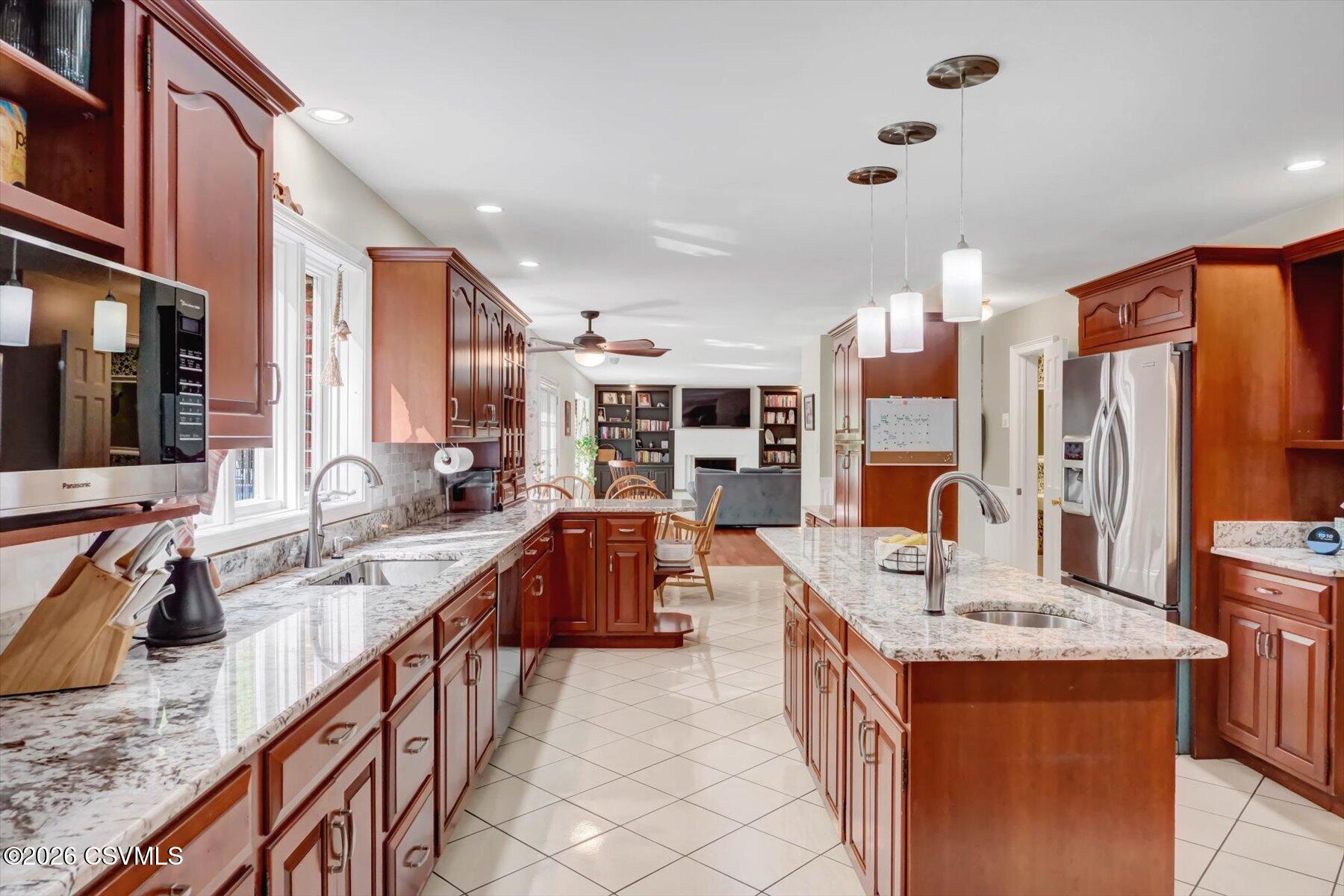 65 Crestview Drive Winfield, PA 17889 - Photo 15 of 70 a large kitchen with stainless steel appliances granite countertop a sink and a refrigerator
